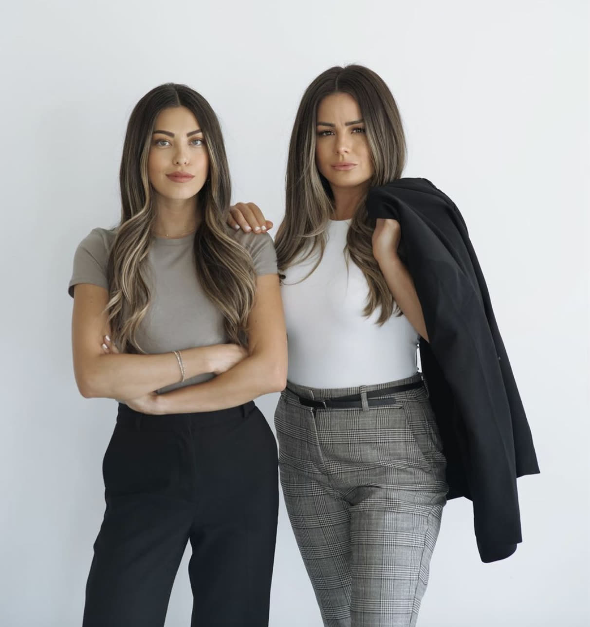 Chanet Smith and Michelle Shaver, the two owners of MIC & NAY Design Collective, photographed against a white wall